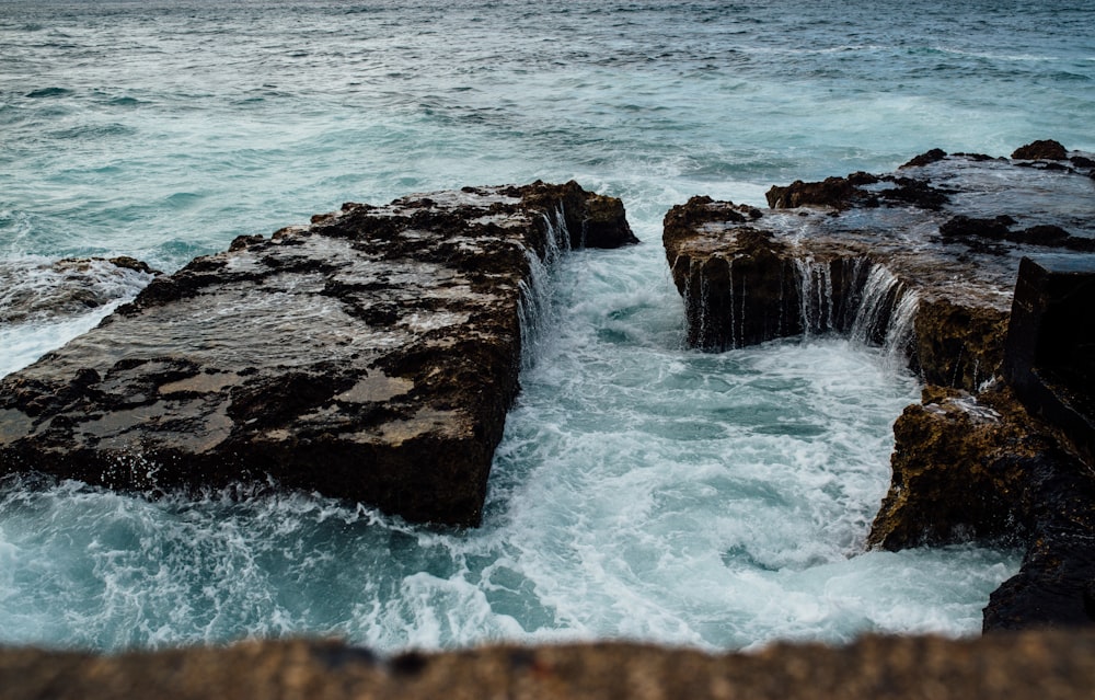 body wave of water near rocks