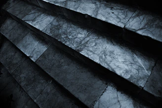 Close-up of a marble staircase with smooth, polished steps in an outdoor setting.