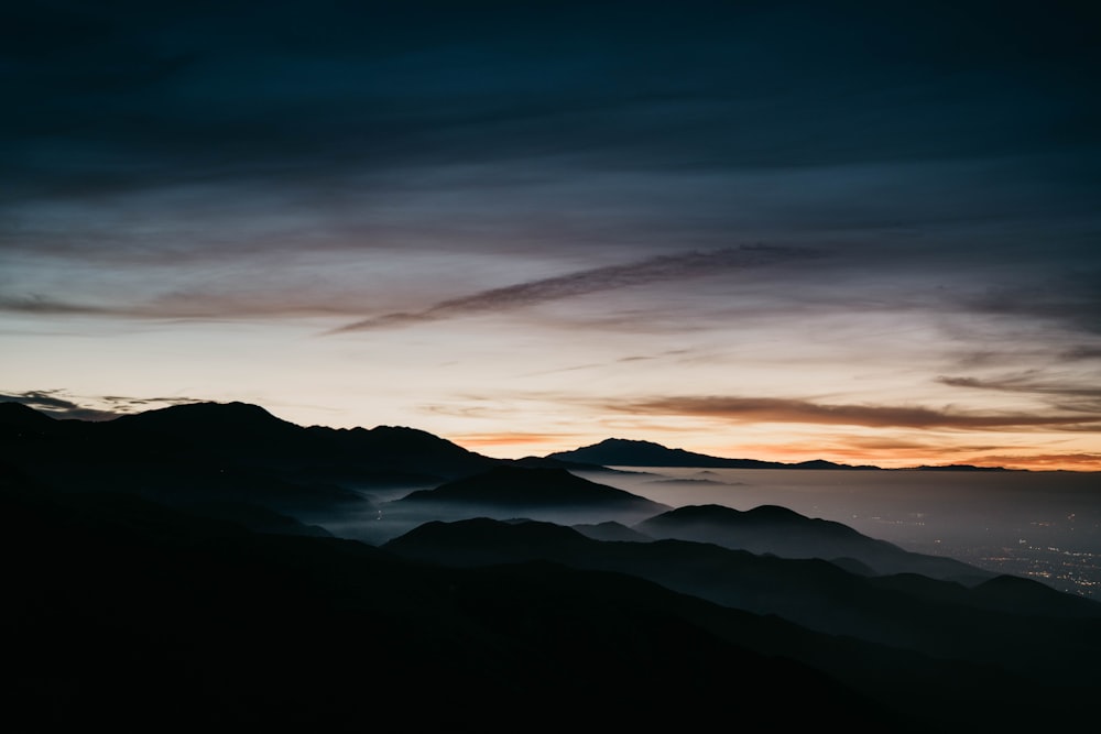 aerial photography of mountain range near body of water