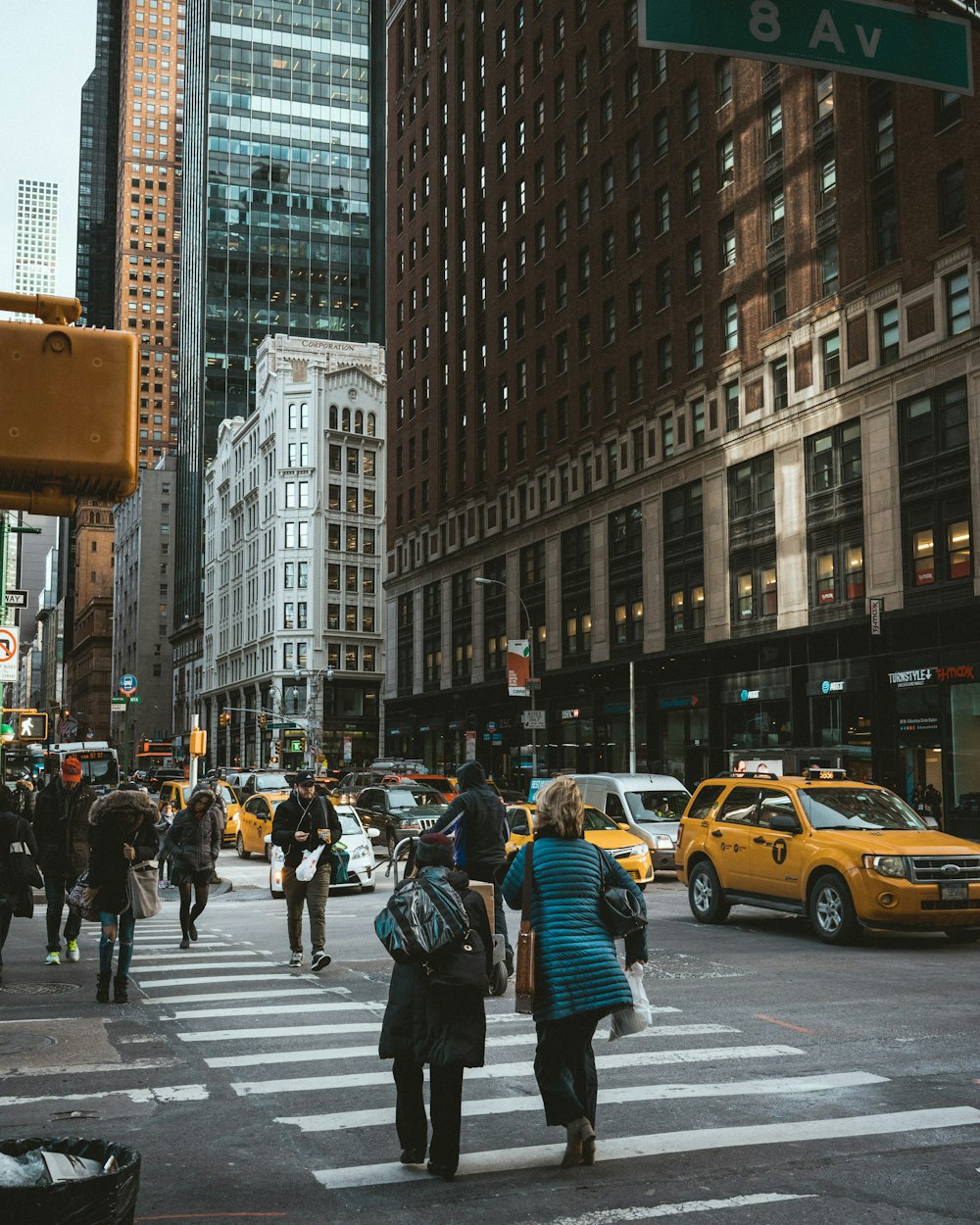 group of people crossing pedestrian lane