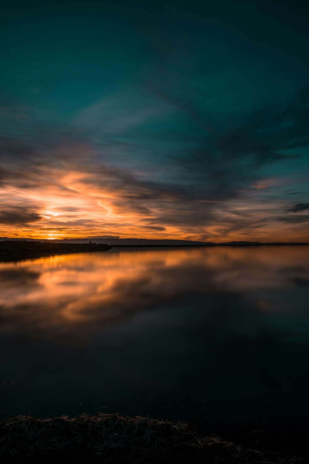 body of water under green sky