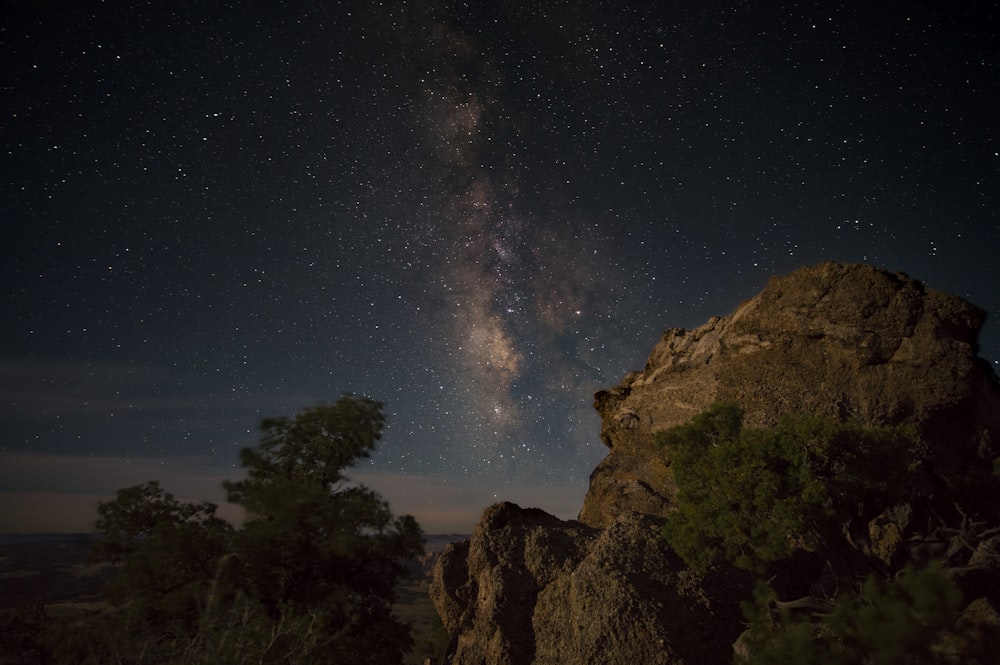 rock formation mountain under sky with stars