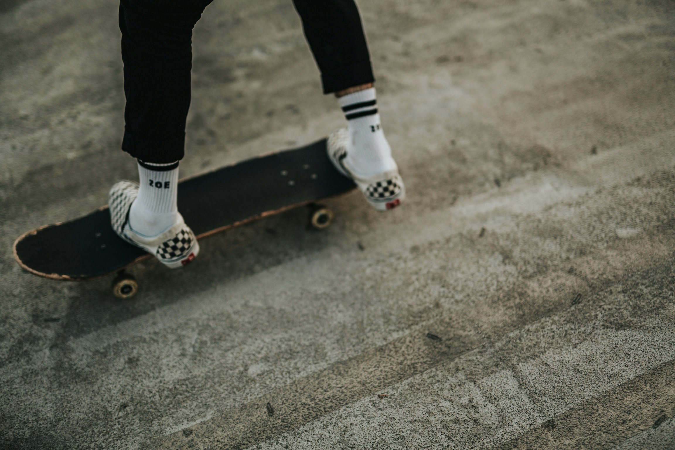 person riding on black skateboard during daytime