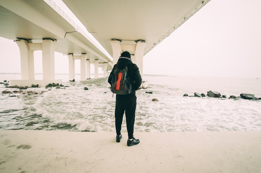 man standing in front of body of water