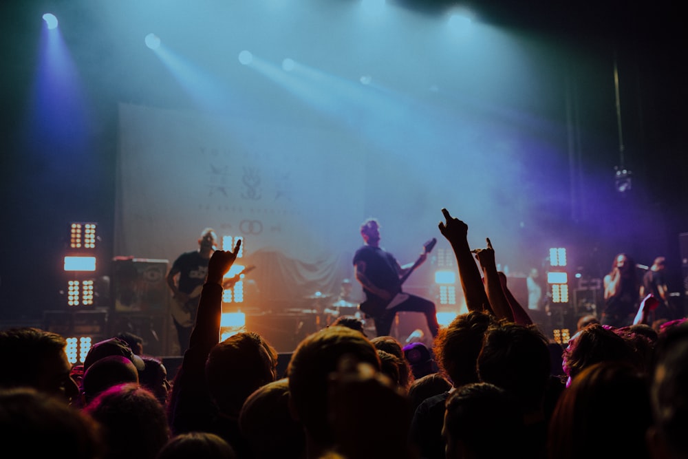 group of band on stage with LED lights