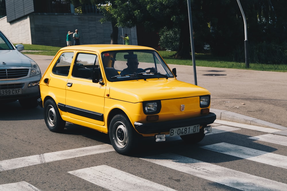 yellow car on concrete road during daytime