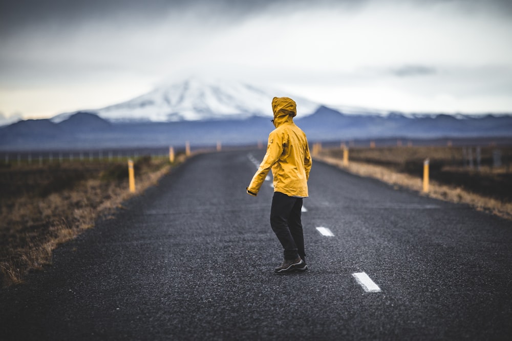 man standing on the middle of the road