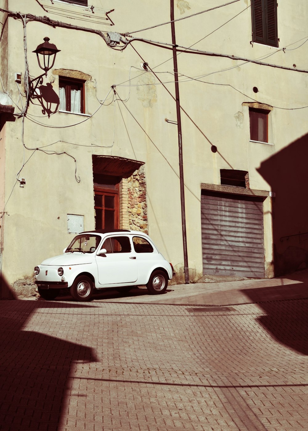 white compact coupe near building during daytime