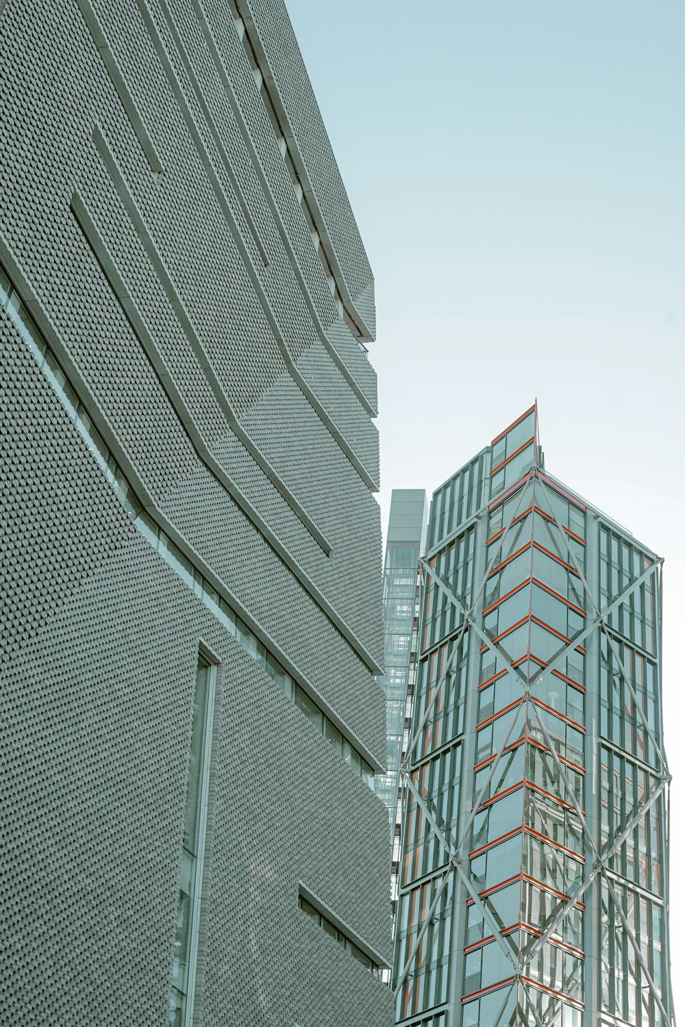 a tall building next to a very tall building