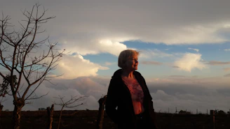 A serene individual embracing a fresh start outdoors at sunrise.