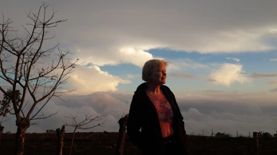 A serene individual embracing a fresh start outdoors at sunrise.
