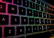 A vibrant keyboard with colorful lights reflecting off its keys during a worship session.