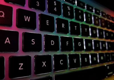 A vibrant keyboard with colorful lights reflecting off its keys during a worship session.
