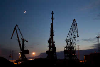 silhouette of metal cranes