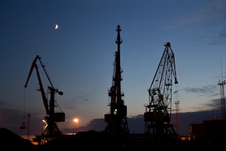 silhouette of metal cranes