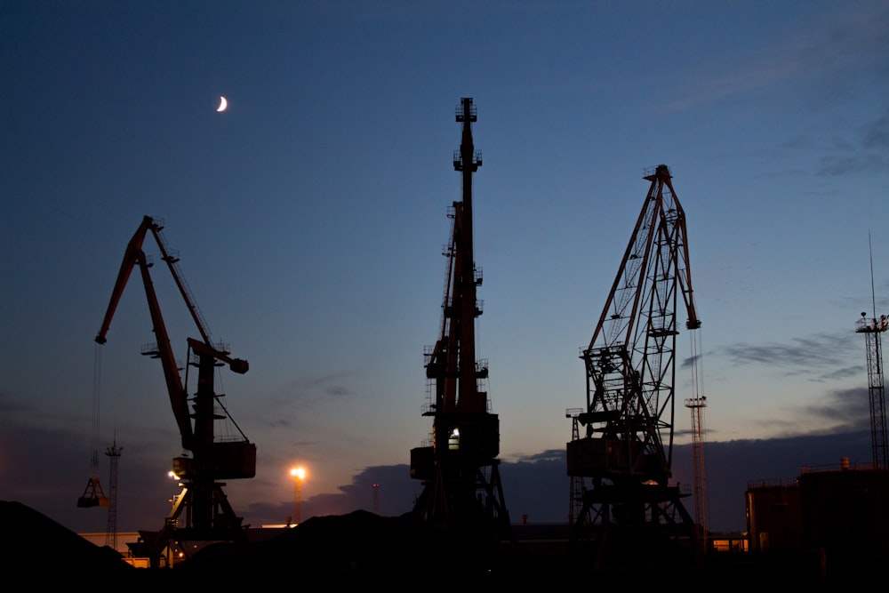 silhouette of metal cranes