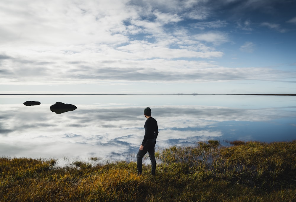 man standing at top of hill