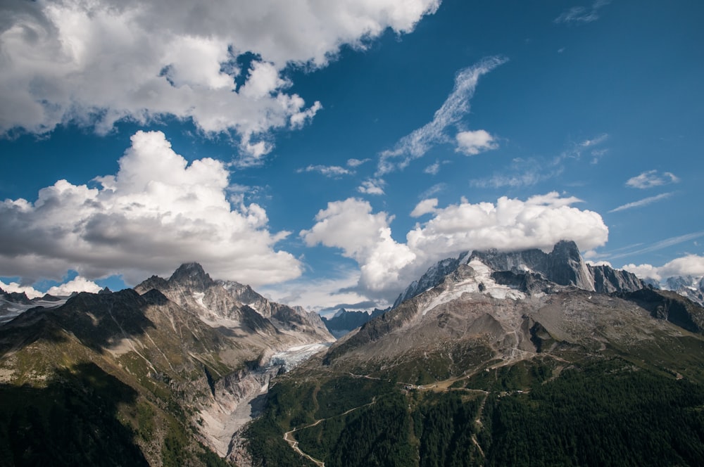 green and brown mountain under white and blue sky