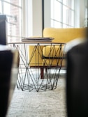selective focus photography of coffee table beside sofa chair
