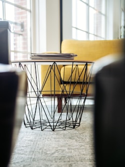 selective focus photography of coffee table beside sofa chair