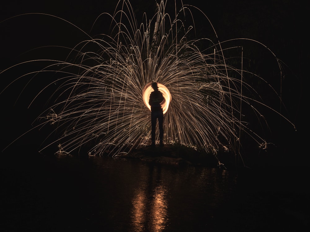 time lapse photography of person standing in front of lights