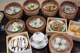 Close-up of intricate dim sum artfully arranged on a bamboo steamer.