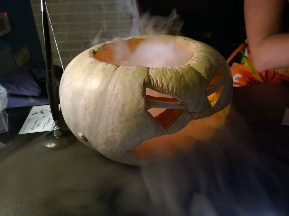 Jack 'o lantern with smoke on sofa armrest