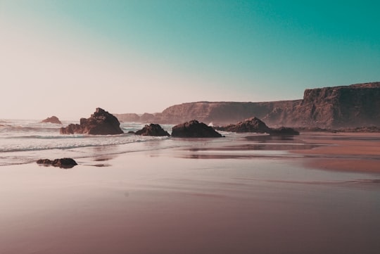 rock formations on seashore during daytime in Praia de Nossa Senhora Portugal