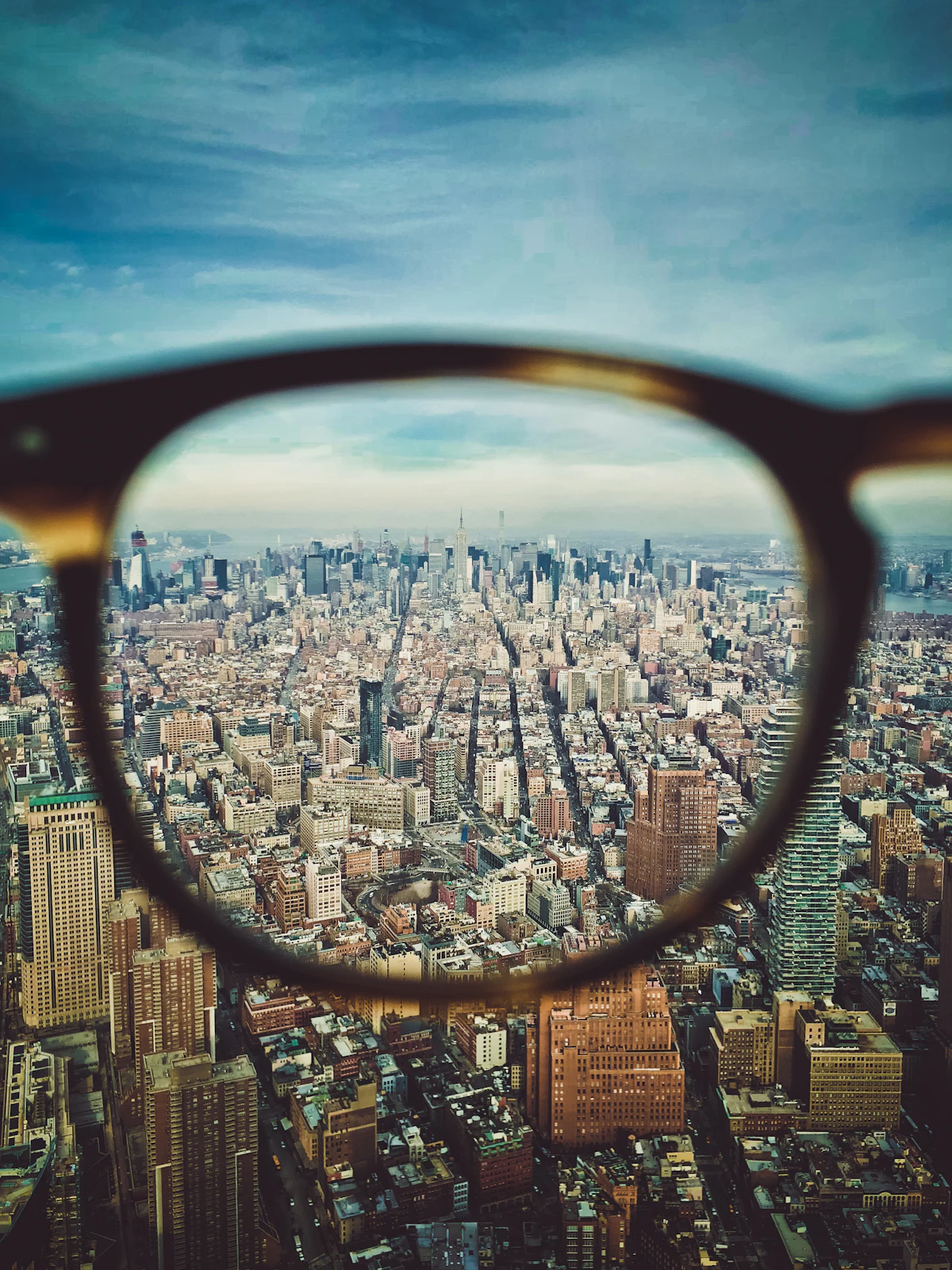 A city appearing sharp through eyeglass lenses