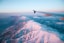 plane flying above white mountains during daytime