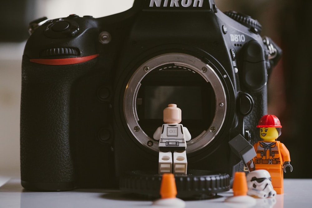 two lego minifigures and nikon D870 camera