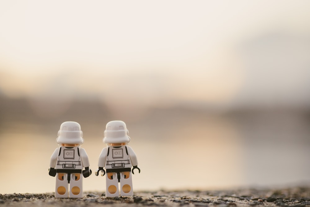 selective focus photography of two white Lego minifigures