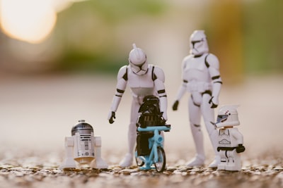 selective focus photography of star wars stormtropper, r2-d2, and darth vader toys parents teams background
