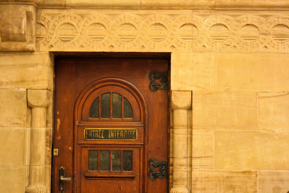 brown wooden door on beige concrete wall