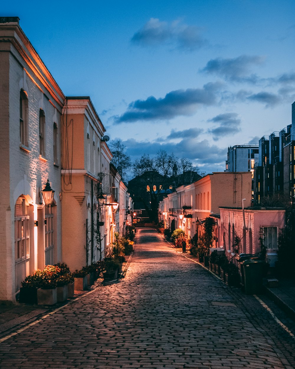 lighted buildings during dark cloudy twilight sky