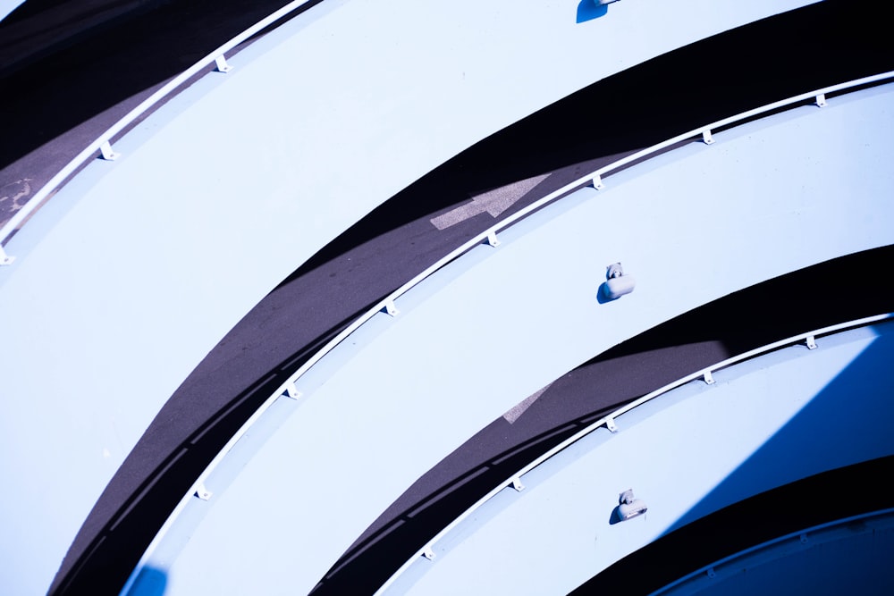 a close up of a curved building with a blue sky in the background
