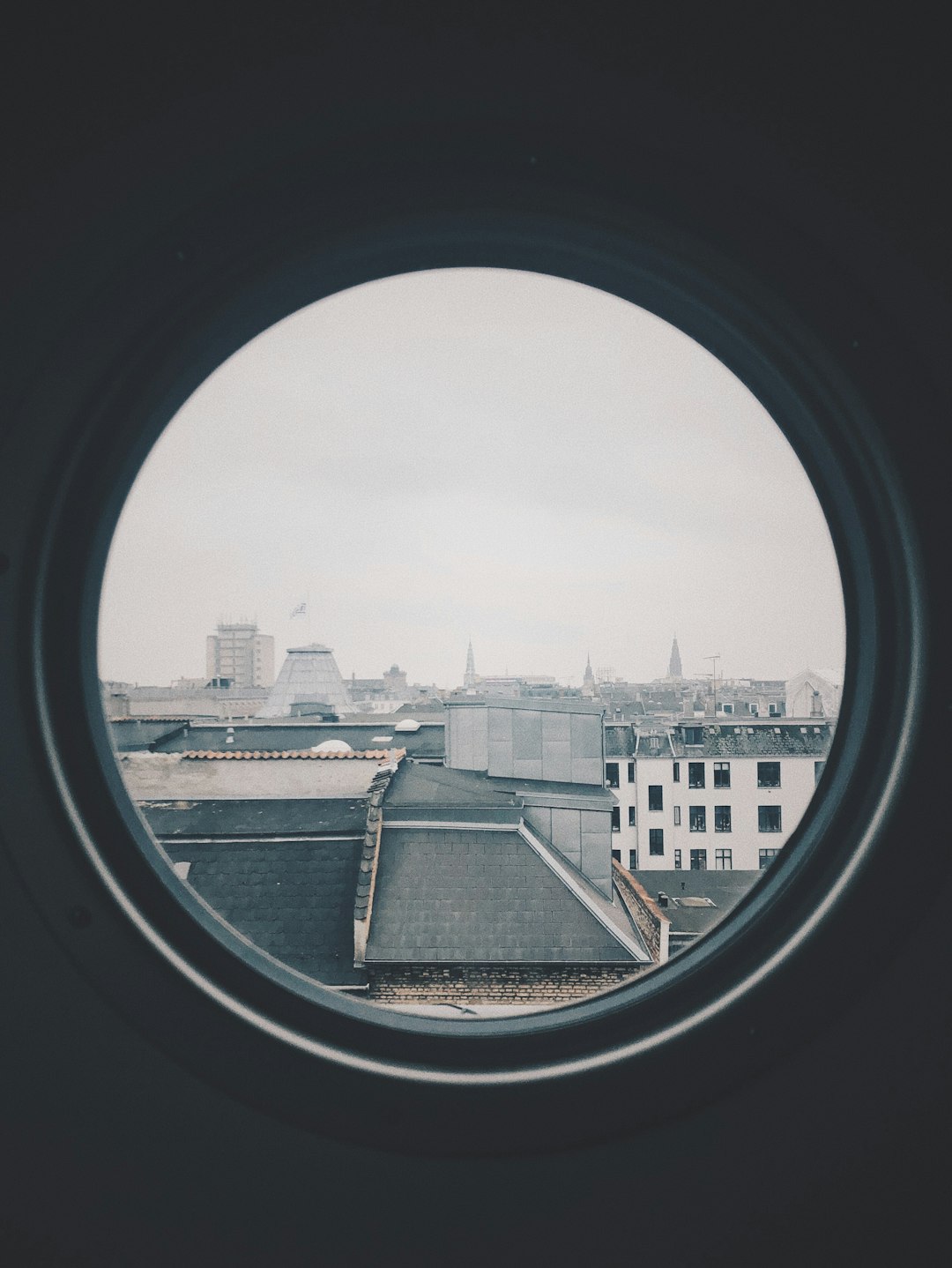  gray concrete buildings at daytime window