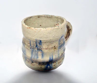 Artisan-crafted ceramic mugs with unique textures and soft pastel colors