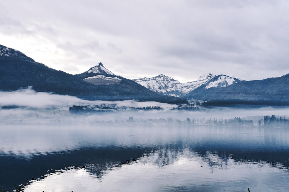 snow-capped mountain near body of water during daytime