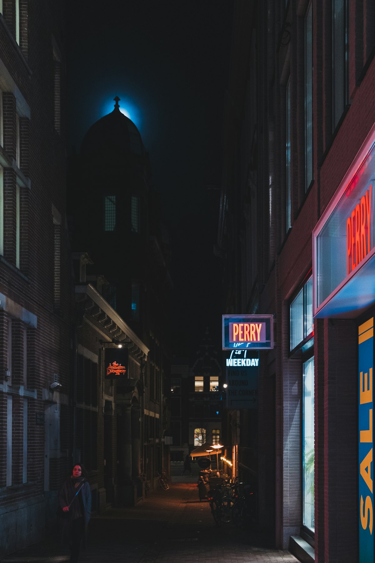 Figure in a neon-lit city at night