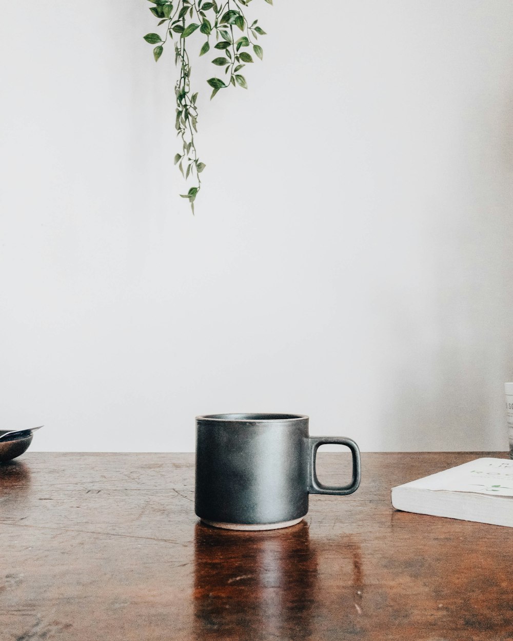 black ceramic mug on brown wooden table