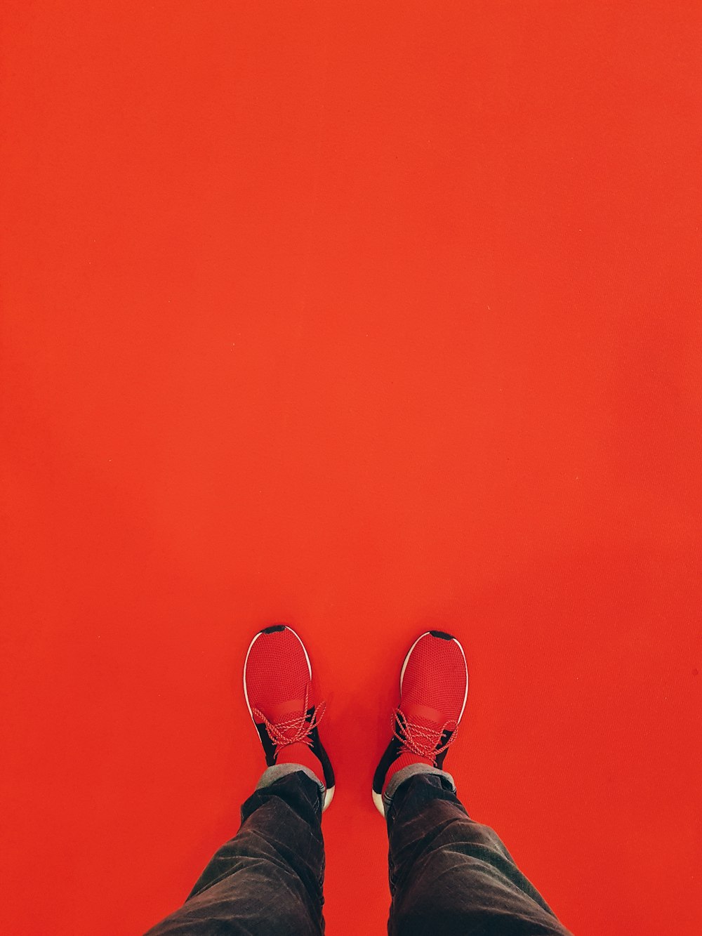 person wearing red running shoe