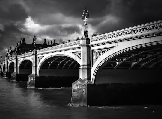 grayscale photo of bridge in Houses of Parliament United Kingdom