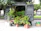 Image of a cargo van parked by a garden center with bags of soil and plants ready to load.