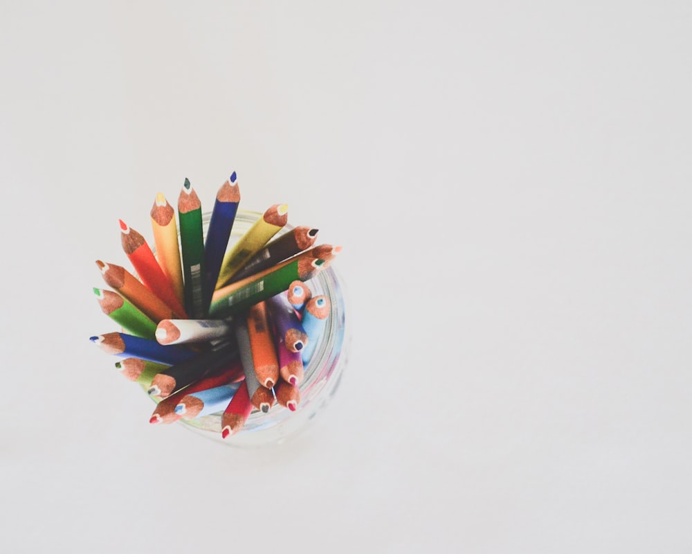 colored pencils in top view photography