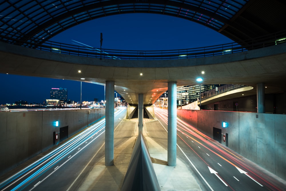 time lapse photograph of vehicle moving on road with skyway