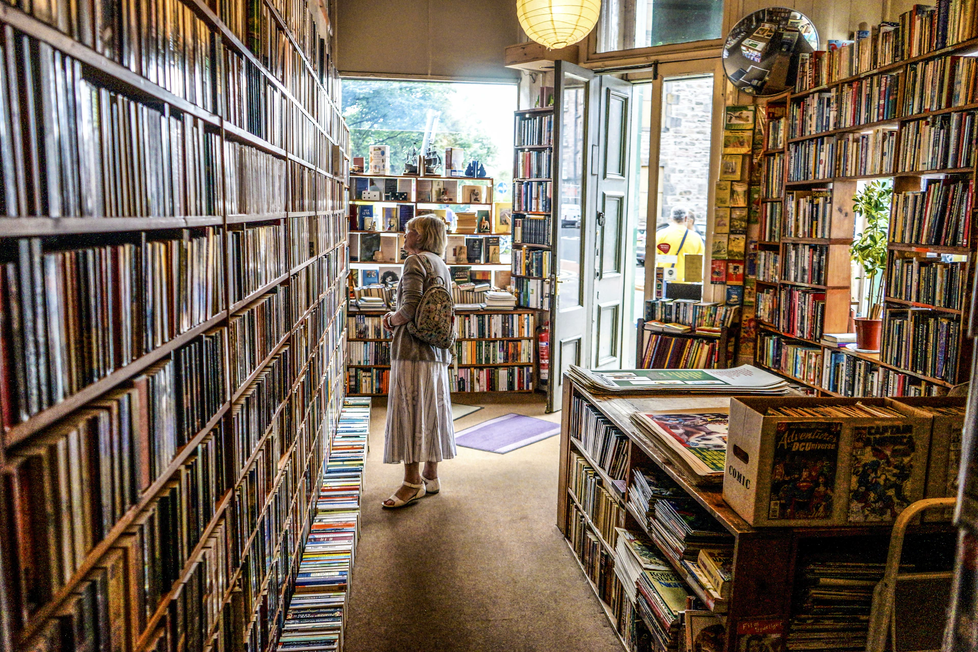 woman inside library looking at books