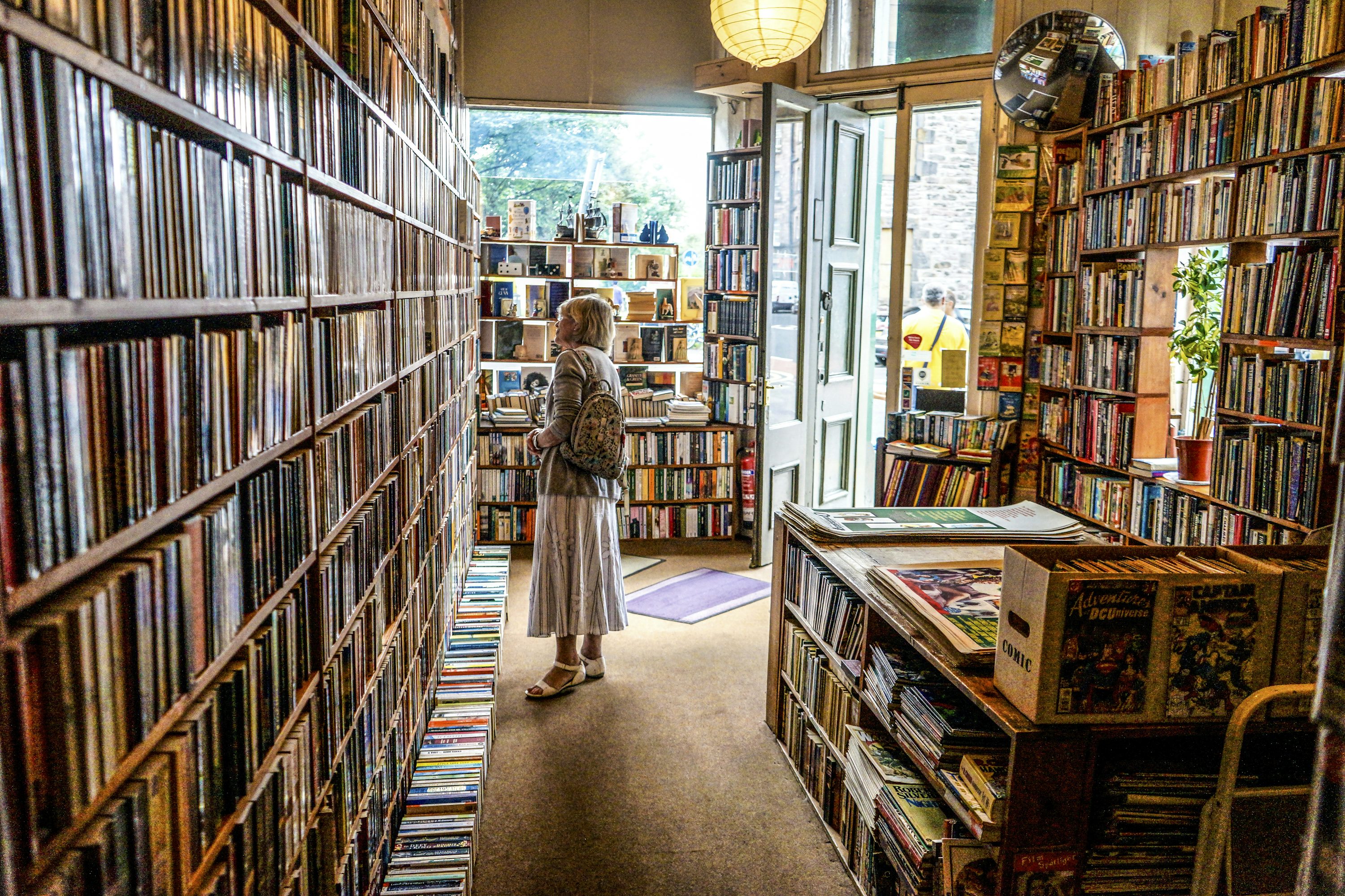 The Ultimate Cozy Fall Solo Date Guide 7 woman inside library looking at books