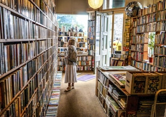 woman inside library looking at books