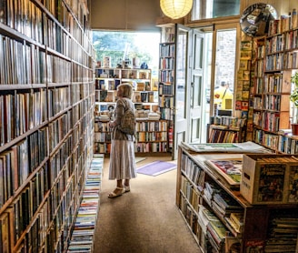 woman inside library looking at books